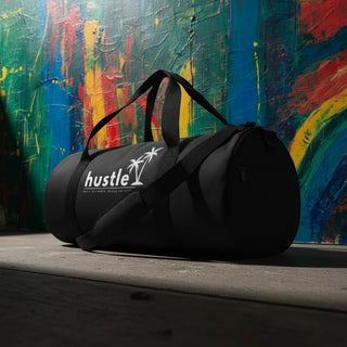 My Store H2Elite heavyweight black cotton canvas duffel bag with white hustle palm tree logo against colorful wall