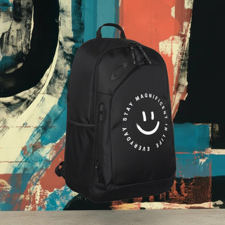 My Store H2Elite 22L Method 360 Ellipse black backpack with a white smiley face graphic against an abstract background.