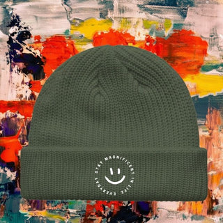 My Store H2Elite™ olive green fisherman beanie with a white circular SMILE logo on the ribbed fold-over cuff.